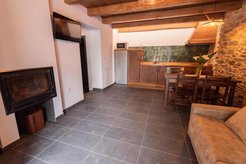 a living room with a couch and a table at Apartamentos Rurales Casa Llongo in Coaña