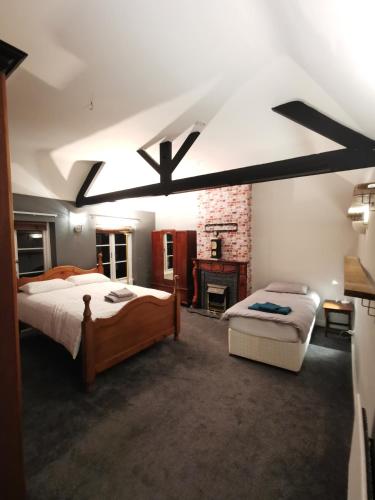 a large bedroom with two beds and a fireplace at House - Sleeps up to 14 & Parking Available in Darlington