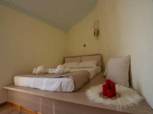 a bedroom with a bed with two red crosses on the floor at Manto Apartments Lefkada in Évyiros