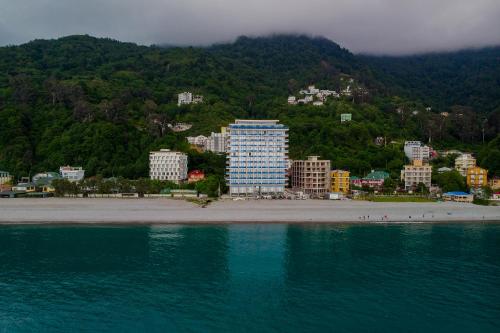 a view of a beach with buildings and the water at Panorama Kvariati in Kvariati