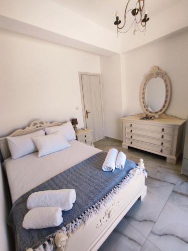 a bedroom with a bed with towels on it at Via Ferrata Houses in Kalymnos