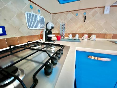 een keuken met een kookplaat en een oven bij Residenza le quattro palme in Alghero
