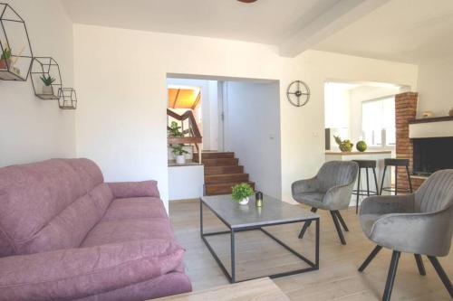 a living room with a couch and chairs and a table at Flora relax house, free parking in Peroj