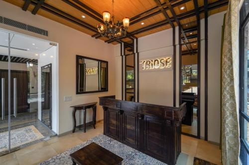 a dressing room with a table and a chandelier at Triose Boutique Hotel Lonavala in Lonavala