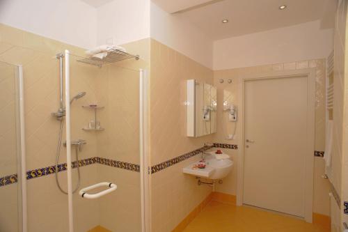 a bathroom with a shower and a sink at Hotel Prater in Grottammare