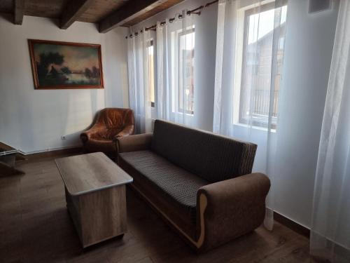 a living room with a couch and a table at Cabana Soral Baile Figa in Beclean