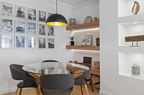 a dining room with a glass table and chairs at Timeless Sea I Apartment in Armação de Pêra