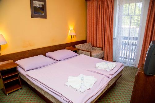 Postel nebo postele na pokoji v ubytování Hotel Prom