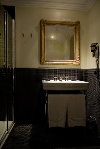 a bathroom with a sink and a mirror at Marcella Royal Hotel - Rooftop Garden in Rome
