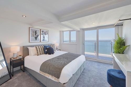 a bedroom with a bed with a view of the ocean at Host & Stay - Pier View Penthouse in Whitby