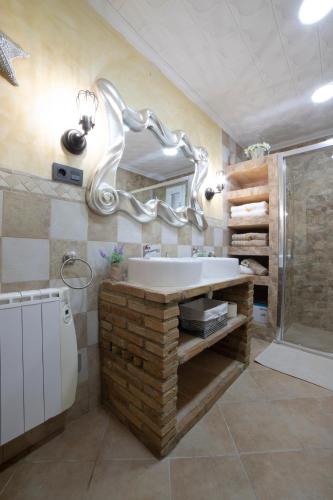 a bathroom with a large tub and a mirror at APARTAMENTO LA VEGUILLA in Alhama de Aragón