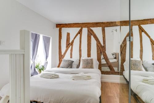 - 2 lits jumeaux dans une chambre avec miroirs dans l'établissement Beautiful Duplex Apt - 5 mins to Grand Rex, à Paris