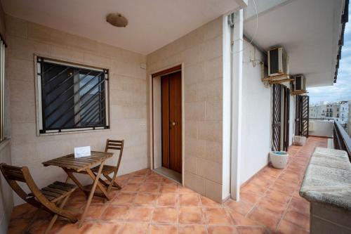 a small dining room with a table and a window at WePuglia - Casa sul Ponte in Polignano a Mare