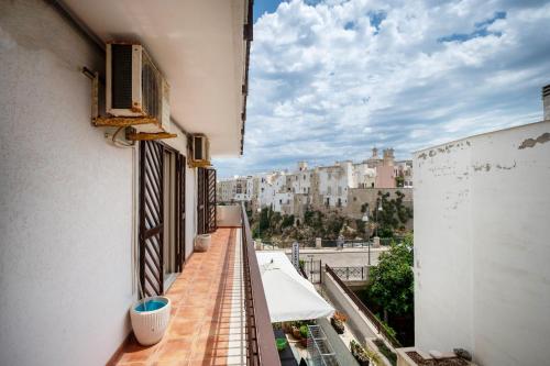 an apartment balcony with a view of a city at WePuglia - Casa sul Ponte in Polignano a Mare