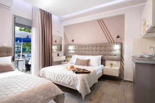 a bedroom with a bed with a cat on it at Denisa Studios in Sarti