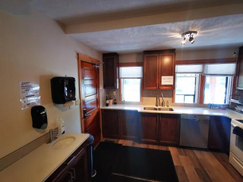 a large kitchen with wooden cabinets and a sink at Riverfront Estate Bed&Breakfast Banff in Banff