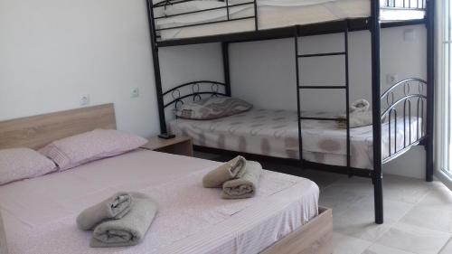 two bunk beds in a room with towels on them at Apartments Vladimir in Agios Nikolaos