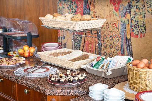 a kitchen counter with baskets of bread and eggs on it at Hotel Astoria Stuttgart City in Stuttgart