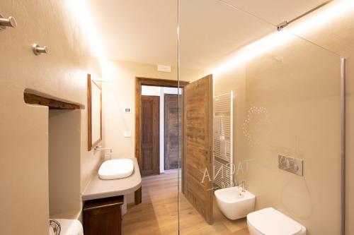 a bathroom with two toilets and a glass shower at Casa Castagna 1620 in Mergozzo