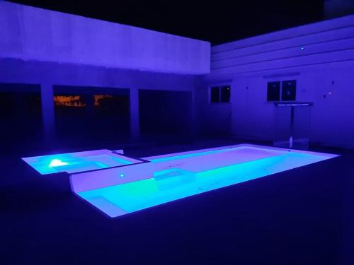 a room with a swimming pool with blue lights at Hotel Uipi in Sorriso