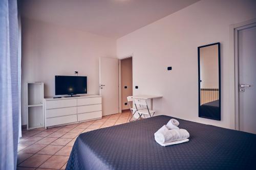 a bedroom with a bed with a towel on it at Travelershome 7Metri GuestHouse in Ciampino