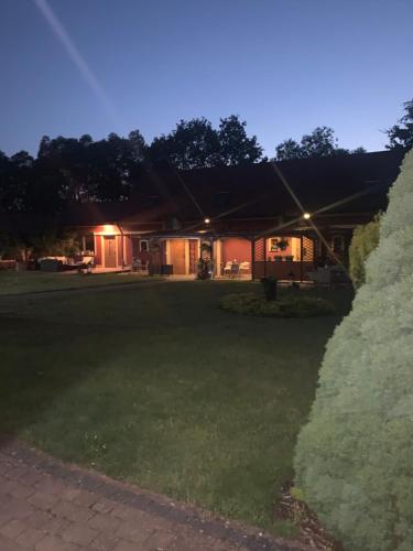 a house at night with the lights on at Agro na Wapniarni in Białla