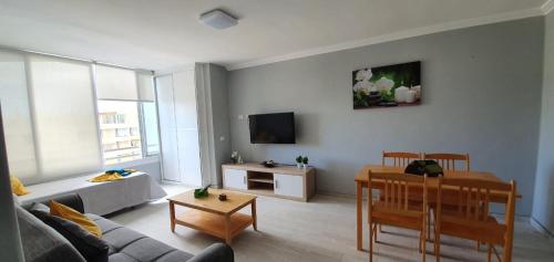 a living room with a couch and a table at Green Park in San Miguel de Abona