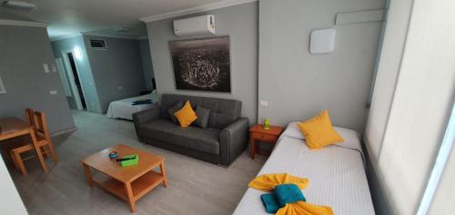 a small living room with a couch and a table at Green Park in San Miguel de Abona
