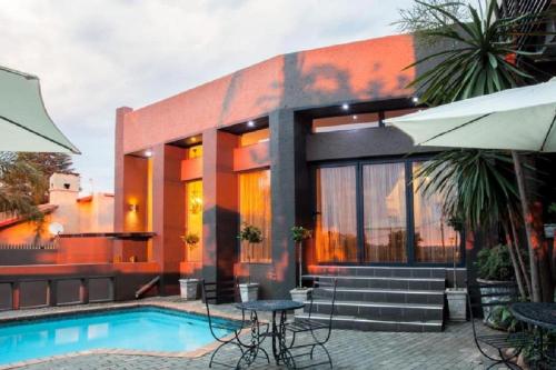 a house with a swimming pool in front of it at Absolut Guest Boutique in Centurion