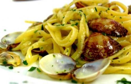 a plate of pasta with meat and mushrooms at Hotel Arno in Misano Adriatico
