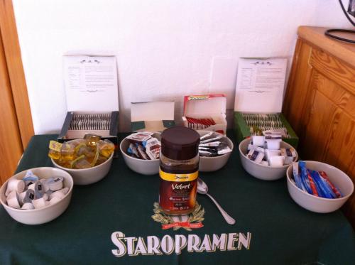 a table topped with four bowls and a bottle of cinnamon at Pension U Václava in Janov