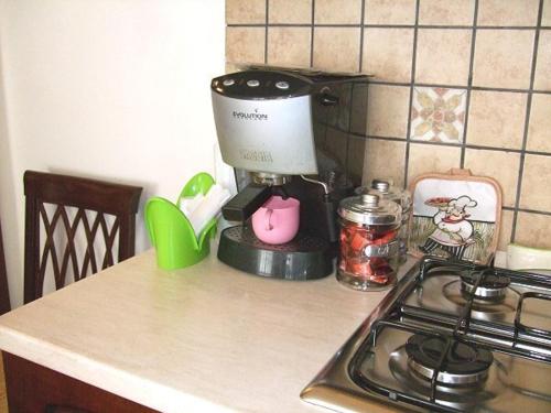 a kitchen counter with a coffee maker and a stove at Anticu Dammusu in Scicli