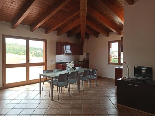 a kitchen and dining room with a table and chairs at Capofrascaresort in Sant' Antonio di Santadi