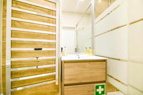 a bathroom with a sink and a mirror at Timeless Beach II Apartment in Armação de Pêra