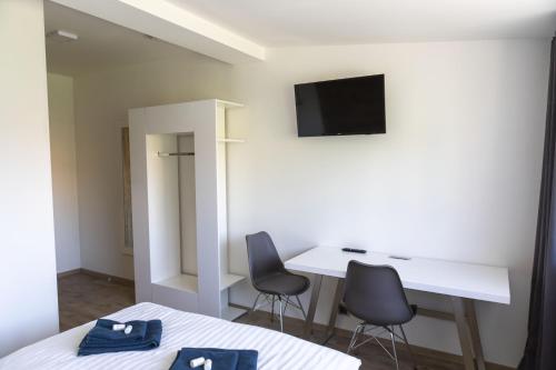 a room with a desk and two chairs and a table at Novohradská in České Budějovice