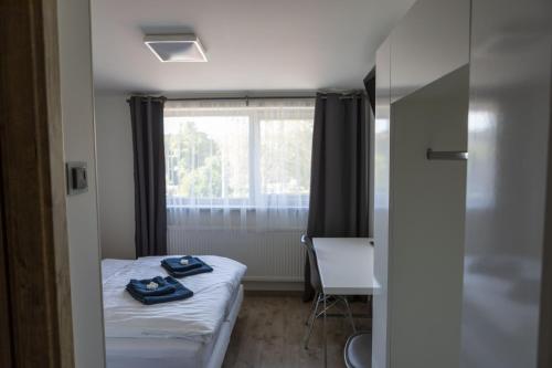 a small room with a bed and a window at Novohradská in České Budějovice