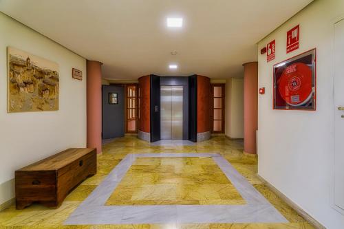 an empty hallway with a door and a wooden table at Jardines de La Santa in Totana