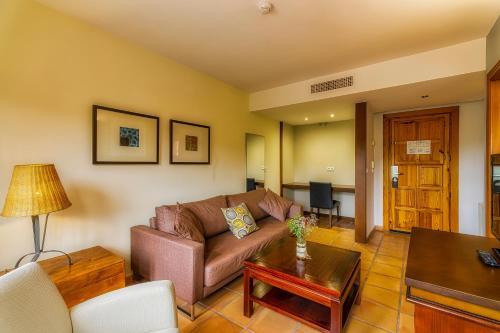 a living room with a couch and a table at Jardines de La Santa in Totana