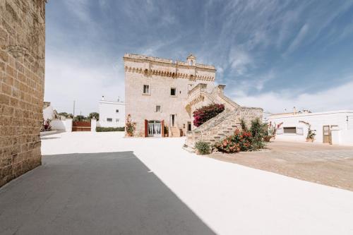 an external view of a building with flowers at Masseria Garrappa in Fasano