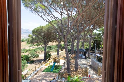 a view of a playground from a window at Feudo Giglio Country Charme in Calatafimi