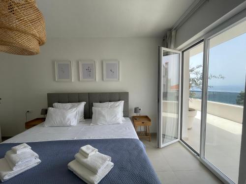a bedroom with a bed with towels on it at Exclusive 2 Bedroom Seafront Suite with jacuzzi in Zavala