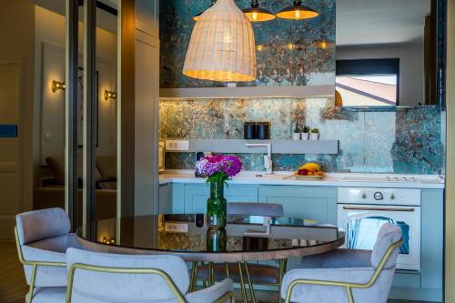 a kitchen with a table with a vase of flowers on it at Rocca Riviera Umag Luxury Apartments in Umag