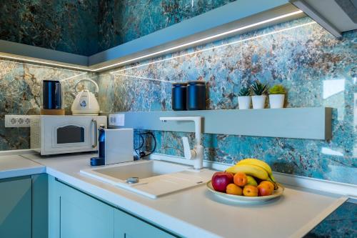 a kitchen with a bowl of fruit on a sink at Rocca Riviera Umag Luxury Apartments in Umag