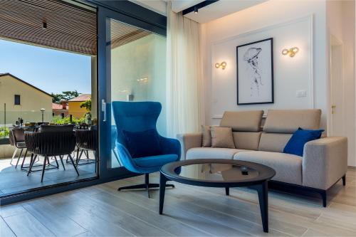 a living room with a couch and a table at Rocca Riviera Umag Luxury Apartments in Umag