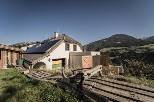 a house with a wooden fence in front of it at Hotel Gasthof Handl in Schönberg im Stubaital
