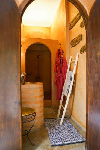a room with a ladder next to a wall with a door at Riad Dama & Spa in Marrakech