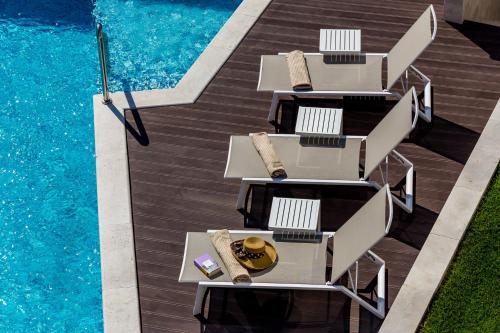an overhead view of tables and chairs next to a swimming pool at Rocca Riviera Umag Luxury Apartments in Umag