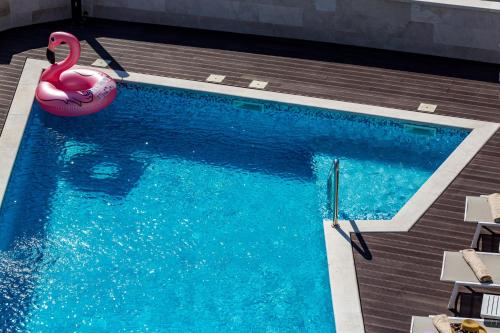 a swimming pool with a swan and a pink flamingo at Rocca Riviera Umag Luxury Apartments in Umag