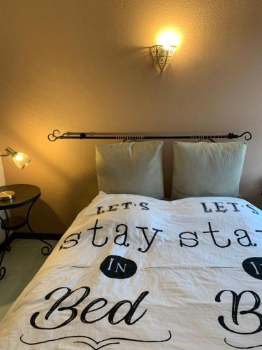 un lit avec les mots restant dans le lit écrit sur lui dans l'établissement Duplex proche mer, à La Rochelle