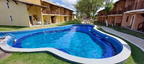a swimming pool in the yard of a house at Aldeia St Sebastien 31 Arembepe in Arembepe